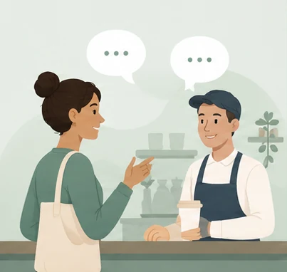 Klant en barista in gesprek bij de koffiebar